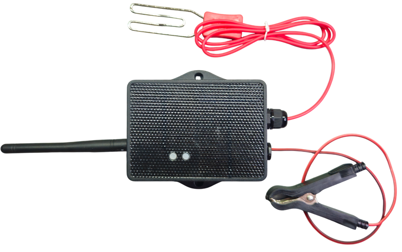 The Hautense monitor installed: antenna up, red wire on the fence, black clamp to ground